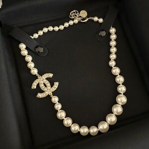 CHANEL Ivory Pearl Necklace with Gold Emblem